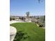 Landscaped backyard with artificial turf and firepit at 2549 W Shinnecock Way, Anthem, AZ 85086