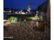 Night view of landscaped backyard with lighting at 2549 W Shinnecock Way, Anthem, AZ 85086