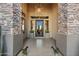 Grand entryway with stone pillars, a modern chandelier, and a glass door at 2549 W Shinnecock Way, Anthem, AZ 85086