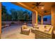 Evening view of a covered patio with comfortable seating at 13050 W Running Deer Trl, Peoria, AZ 85383