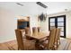 Elegant dining room with a large wooden table and modern chandelier at 4632 E Desert Park Pl, Paradise Valley, AZ 85253