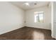 Spacious bedroom featuring wood floors and a window with a view at 2326 W Gloria Ln, Phoenix, AZ 85085