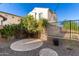 Circular paved patio area in a backyard with gravel and landscaping at 2326 W Gloria Ln, Phoenix, AZ 85085