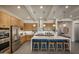 Modern kitchen with island, stainless steel appliances, and blue tile backsplash at 1427 E Cherrywood Pl, Chandler, AZ 85249