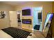 Modern bedroom with a wall-mounted fireplace, a large TV, and an ensuite bathroom at 2046 N Dayton St, Phoenix, AZ 85006