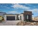 Modern home exterior with stone accents and a two-car garage at 1417 E Cherrywood Pl, Chandler, AZ 85249