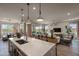 Open kitchen with island, modern light fixtures and a view to the living room at 1417 E Cherrywood Pl, Chandler, AZ 85249