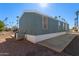 Mobile home exterior view, showing side profile and landscaping at 2600 E Allred Ave # R82, Mesa, AZ 85204