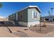 Mobile home exterior, blue siding, white trim, steps, and a small yard at 2600 E Allred Ave # R82, Mesa, AZ 85204