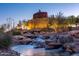 Serene water feature with a lit stone structure at 10919 S Dreamy Dr, Goodyear, AZ 85338