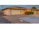 Brick ranch home with solar panels, attached garage, and landscaped yard at 10712 W Saratoga Cir, Sun City, AZ 85351