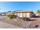 House exterior showcasing the landscaping and rock features at 10712 W Saratoga Cir, Sun City, AZ 85351