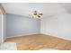 Living room with wood flooring, ceiling fan and sliding door at 13318 W Stonebrook Dr, Sun City West, AZ 85375