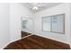 Bright bedroom featuring wood flooring and mirrored closet doors at 17006 N 44Th Pl, Phoenix, AZ 85032