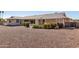 Spacious backyard with gravel landscaping and mature shrubs at 11110 W Peace Ct, Sun City, AZ 85351