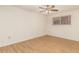 Bedroom with laminate flooring and french doors at 11110 W Peace Ct, Sun City, AZ 85351