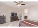 Spacious bedroom with dresser, TV and ensuite bathroom at 1684 S Desert View Pl, Apache Junction, AZ 85120