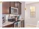 Kitchen with stainless steel appliances and dark cabinets at 1684 S Desert View Pl, Apache Junction, AZ 85120