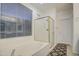 Bathroom featuring a bathtub, shower, and window at 218 E Sunburst Ln, Tempe, AZ 85284