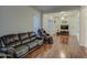 Living room features hardwood floors and a comfortable leather couch at 218 E Sunburst Ln, Tempe, AZ 85284