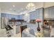 Bright kitchen with glass-top table, blue cabinets, and granite countertops at 218 E Sunburst Ln, Tempe, AZ 85284