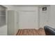Simple bedroom with wood flooring and double door closet at 218 E Sunburst Ln, Tempe, AZ 85284