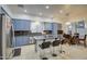 Eat-in kitchen boasts granite countertops, stainless steel appliances, and blue cabinets at 218 E Sunburst Ln, Tempe, AZ 85284