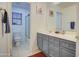 Bathroom boasts double sinks, grey cabinets, and a shower/tub combo at 218 E Sunburst Ln, Tempe, AZ 85284