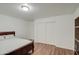 Well-lit bedroom with wood floors and double closets at 218 E Sunburst Ln, Tempe, AZ 85284