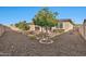 Spacious backyard with gravel, trees, and a block wall at 11407 W Duane Ln, Peoria, AZ 85383