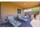 Covered patio with built-in grill and lounge chairs at 12473 W Montgomery Rd, Peoria, AZ 85383