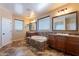 Primary bathroom with double vanity, soaking tub, and tiled flooring at 12473 W Montgomery Rd, Peoria, AZ 85383