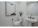 Simple powder room with pedestal sink and toilet at 17149 W Middlebury St, Surprise, AZ 85388