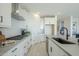 White kitchen with a herringbone backsplash and black sink at 17149 W Middlebury St, Surprise, AZ 85388