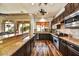 Open kitchen features granite countertops, dark wood cabinets, and a breakfast bar at 3219 S Silverberry Ct, Gold Canyon, AZ 85118