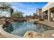 Relaxing kidney shaped pool with waterfall feature and large rocks at 3318 N Brighton --, Mesa, AZ 85207