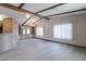 Living room with wood-beamed ceilings, light wood floors, and built-in cabinets at 9302 E Broadway Rd # 9, Mesa, AZ 85208