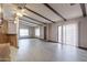 Living room with wood-beamed ceilings, light wood floors, and access to exterior at 9302 E Broadway Rd # 9, Mesa, AZ 85208