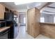 Kitchen area with black refrigerator, wood cabinets, and vinyl flooring at 9302 E Broadway Rd # 9, Mesa, AZ 85208
