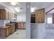 View of kitchen with wood cabinets, a peninsula, and vinyl flooring at 9302 E Broadway Rd # 9, Mesa, AZ 85208