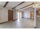 Living room with wood-beamed ceilings, light wood floors, and sliding glass door at 9302 E Broadway Rd # 9, Mesa, AZ 85208
