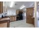 Kitchen features wood cabinets, black appliances, and light vinyl flooring at 9302 E Broadway Rd # 9, Mesa, AZ 85208