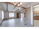 Open living room with wood-beamed ceilings, light wood floors and access to kitchen at 9302 E Broadway Rd # 9, Mesa, AZ 85208