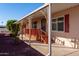 Covered porch with decorative metal railings and wooden steps leading to the entrance at 9302 E Broadway Rd # 9, Mesa, AZ 85208