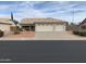 Three-car garage and desert landscaping at 20407 N 107Th Dr, Sun City, AZ 85373