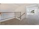 Upstairs hallway with metal railing and carpet flooring at 1207 N Velero St, Chandler, AZ 85225