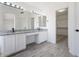 Elegant bathroom with double vanity, granite countertop, and walk-in closet at 1207 N Velero St, Chandler, AZ 85225
