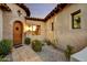 Inviting entryway with arched doorway and gravel landscaping at 3219 S Silverberry Ct, Gold Canyon, AZ 85118