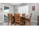 Casual dining area with wooden table and chairs, near sliding door at 9746 E Thornbush Ave, Mesa, AZ 85212