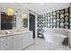 Stylish bathroom with patterned wallpaper, freestanding tub, and white vanity at 7046 N 59Th Pl, Paradise Valley, AZ 85253